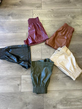 Load image into Gallery viewer, P21037 Faux leather high waisted shorts featuring elastic waistband. Pocket at sides.