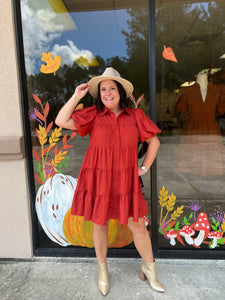 D21143 Solid button up tiered mini dress featuring puff sleeves.