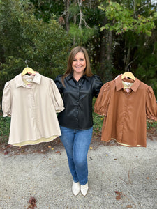 T21931 Faux leather collared short sleeve top featuring puff sleeve. Button-down closure.