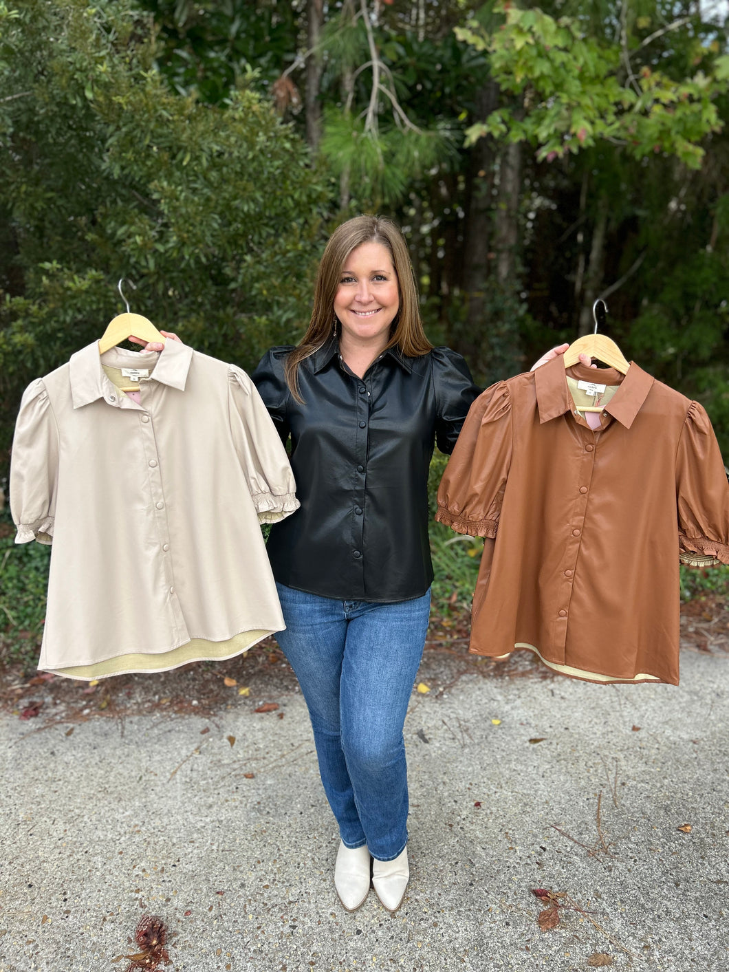 T21931 Faux leather collared short sleeve top featuring puff sleeve. Button-down closure.