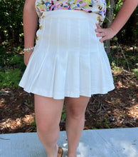 Load image into Gallery viewer, Denim pleated mini skirt featuring gold accented button closures