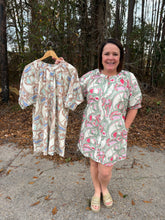 Load image into Gallery viewer, Printed short puff sleeve mini dress featuring gathered neckline. Button closure at front. Side pockets.