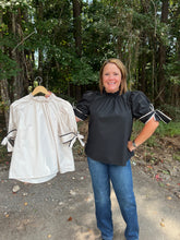 Load image into Gallery viewer, T24241 Solid mock neck short sleeve top featuring ruffled neckline. Self-tie bow detail at cuff. Button closure at back