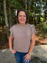 Load image into Gallery viewer, Solid cap sleeve top featuring metal flower accent at shoulder