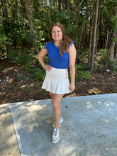 Load image into Gallery viewer, Denim pleated mini skirt featuring gold accented button closures