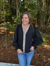 Load image into Gallery viewer, Solid long sleeve top featuring animal printed contrast at front placket and neckline. Smocked cuffs.
