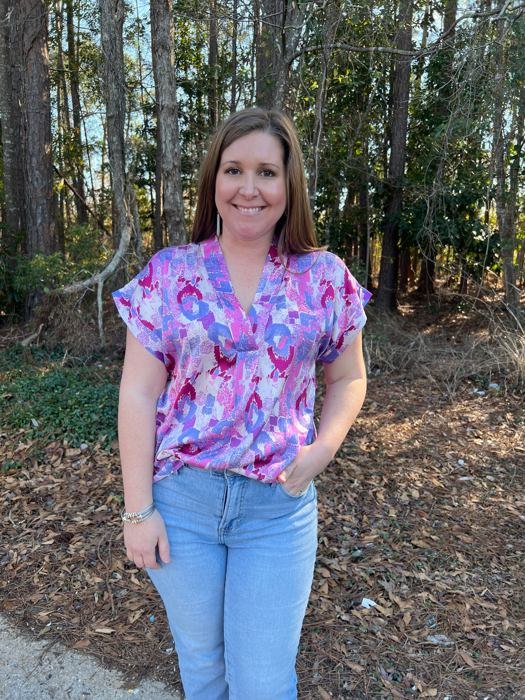 T22255 Printed v-neck short sleeve top featuring permanent rolled cuffs.