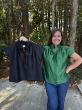 Load image into Gallery viewer, Solid cap sleeve top with a ruffled high neckline. Hidden buttons at front.