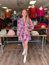 Load image into Gallery viewer, D21233 Floral print long sleeve tiered mini dress featuring smocking detail at front. Self tie at front. Pockets at side.