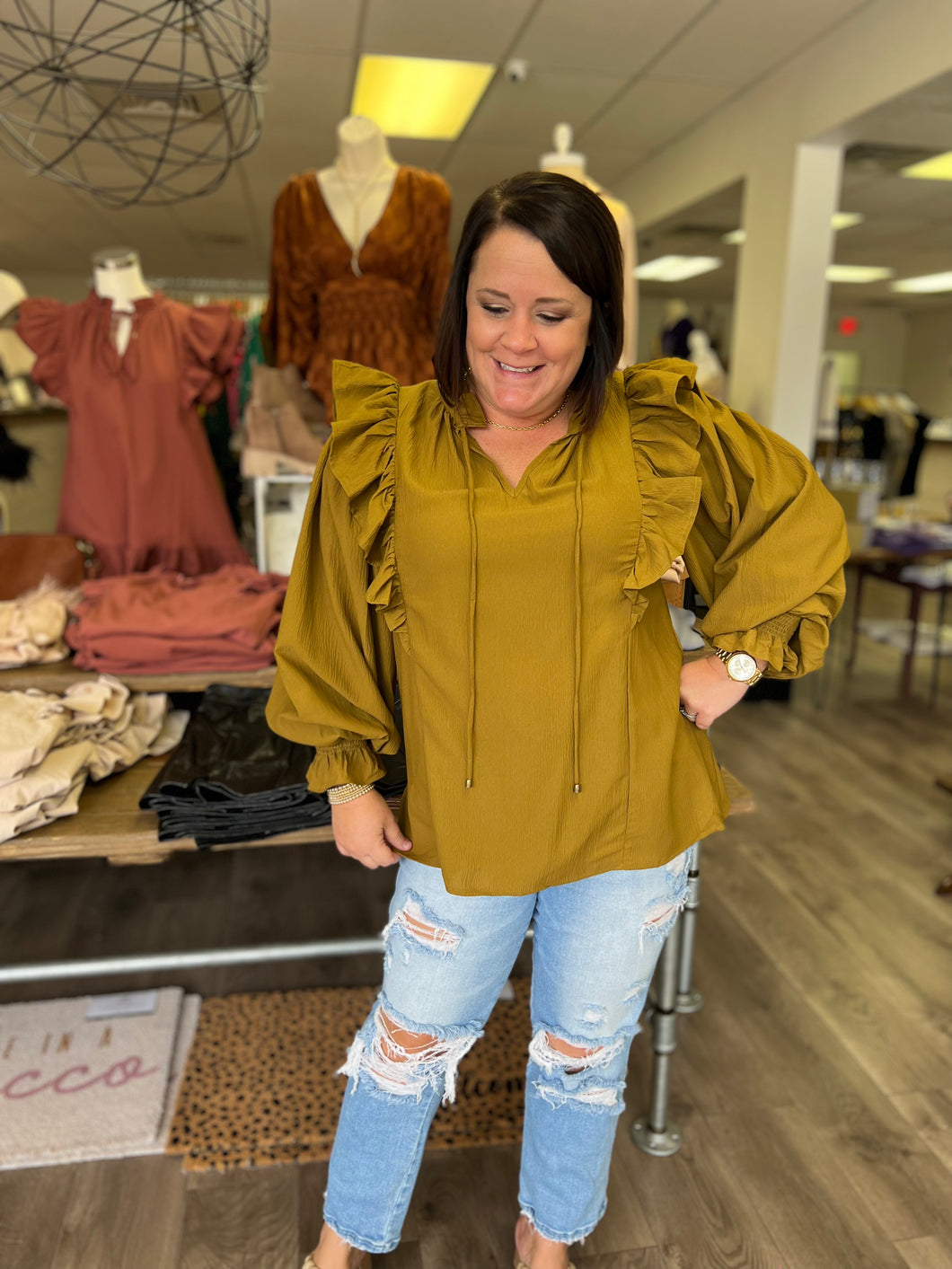 T19069 Textured v-neck long sleeve top featuring ruffle detailing at sleeve