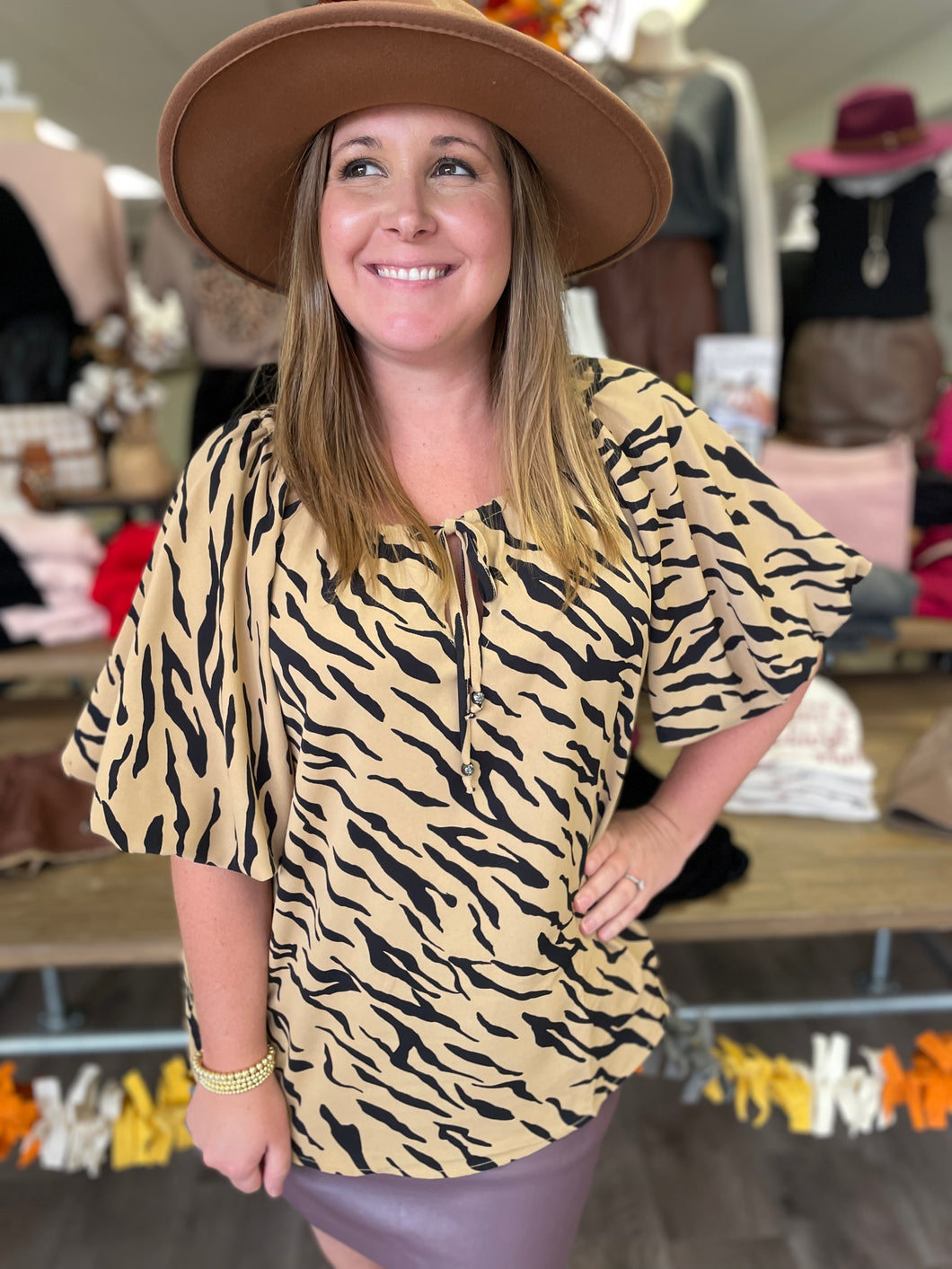 T19318 Animal print round neck puff sleeve top featuring self tie at front